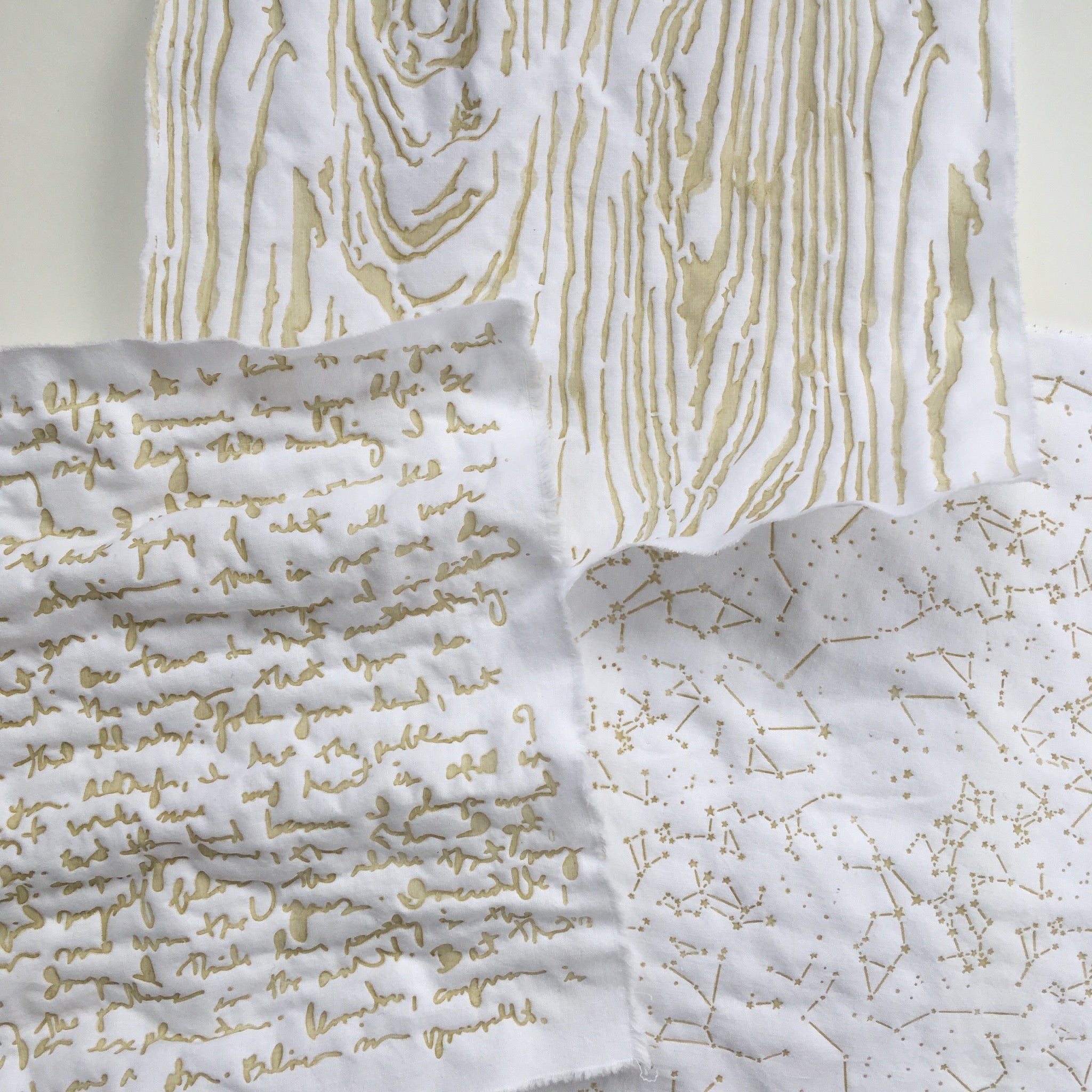 Fabrics showing examples of painted and stencilled on clay resist before dyeing