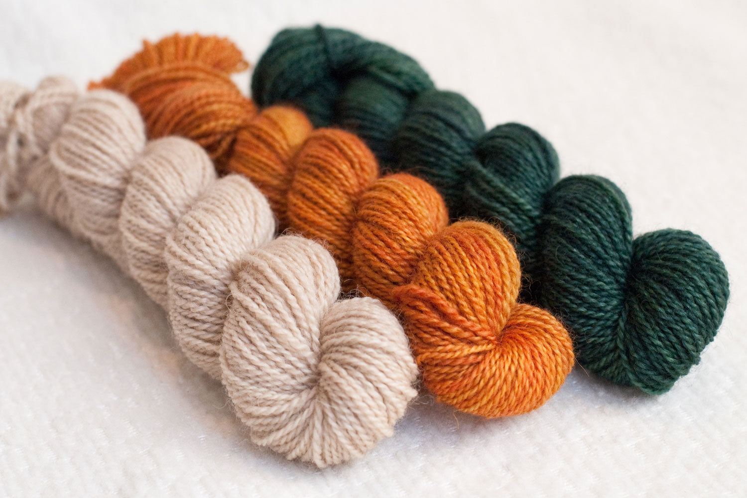 Pumpkin Patch gnome yarn set of three hand-dyed mini-skeins in cream, orange, and dark green, for gnomei mystery knitalong 9 with Imagined Landscapes