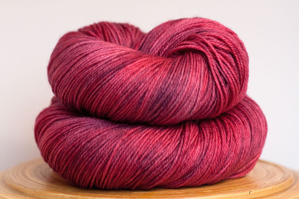 Cosmopolitan semi-solid pink fingering weight hand-dyed yarn