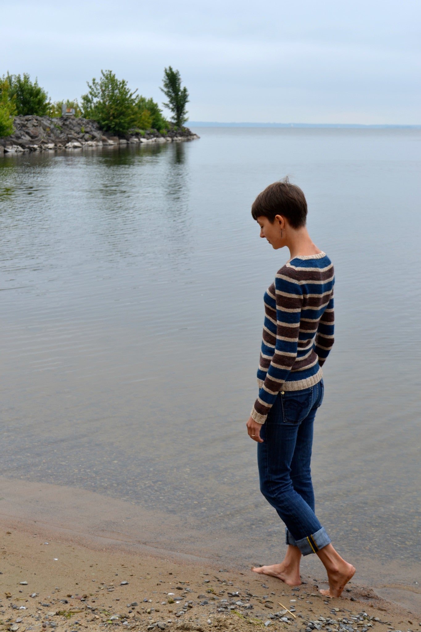 Stillness knitting pattern worn with jeans on the beach